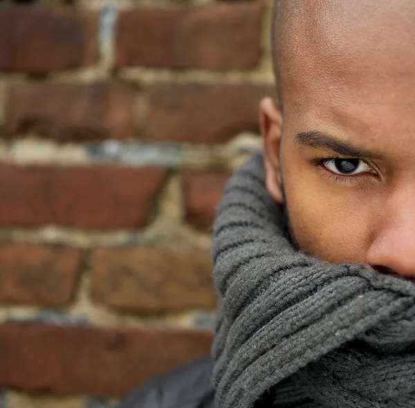 Attractive male fashion model with scarf covering face — Stockfoto