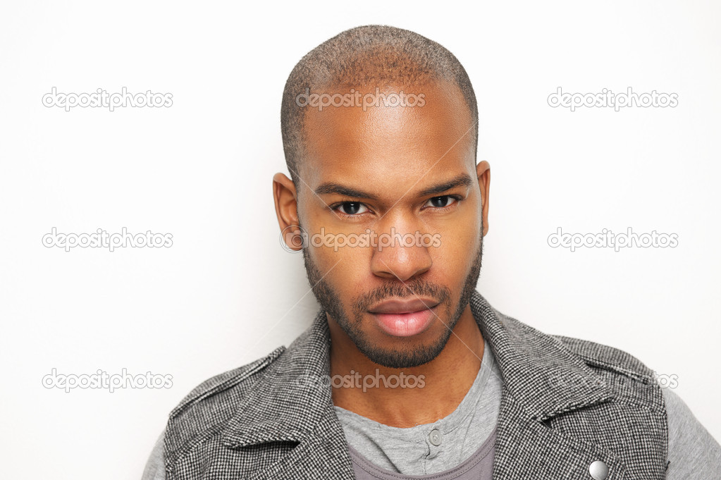 Attractive young black man against white wall