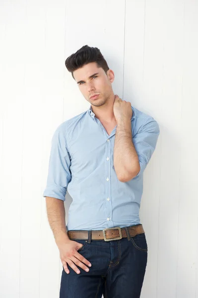 Handsome young man standing against white background — Stock Photo, Image