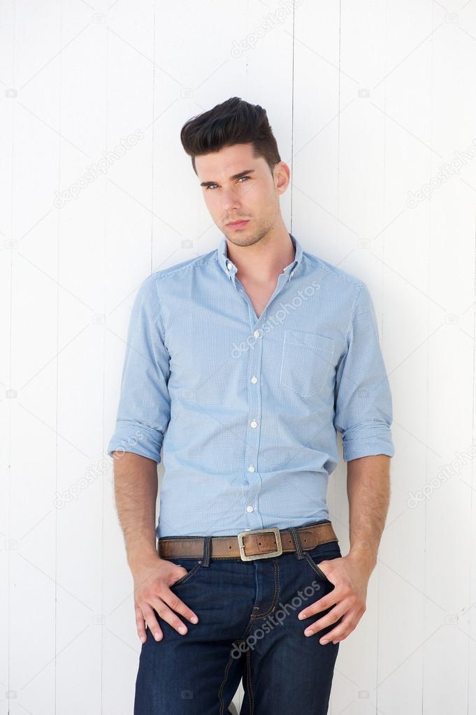 Attractive male fashion model in blue jeans and shirt