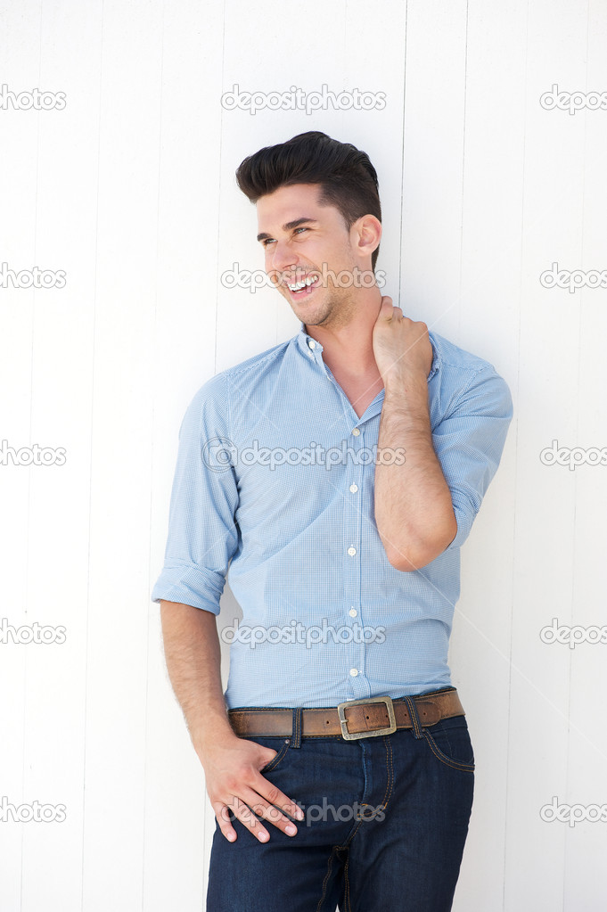Attractive young man smiling against white background