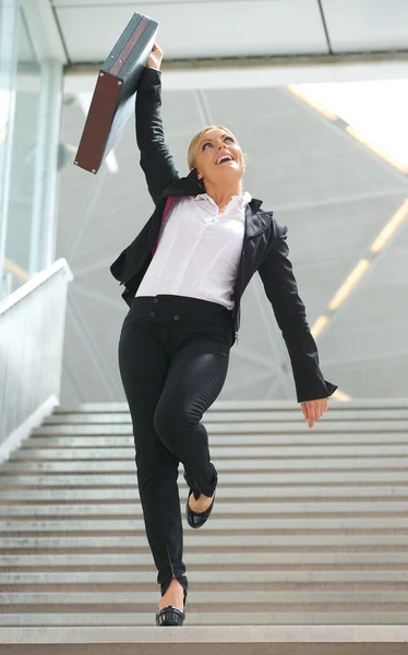 Successful business woman celebrating with arms raised — Stock Photo, Image