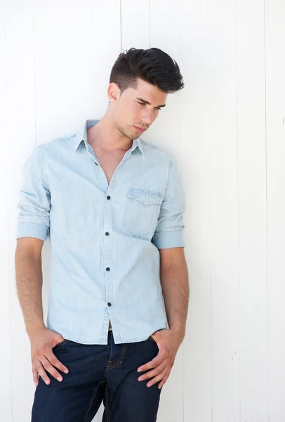 Attractive man standing outdoors with hands in pocket — Stock Photo, Image