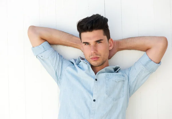 Attractive male fashion model with hands behind head — Stock Photo, Image