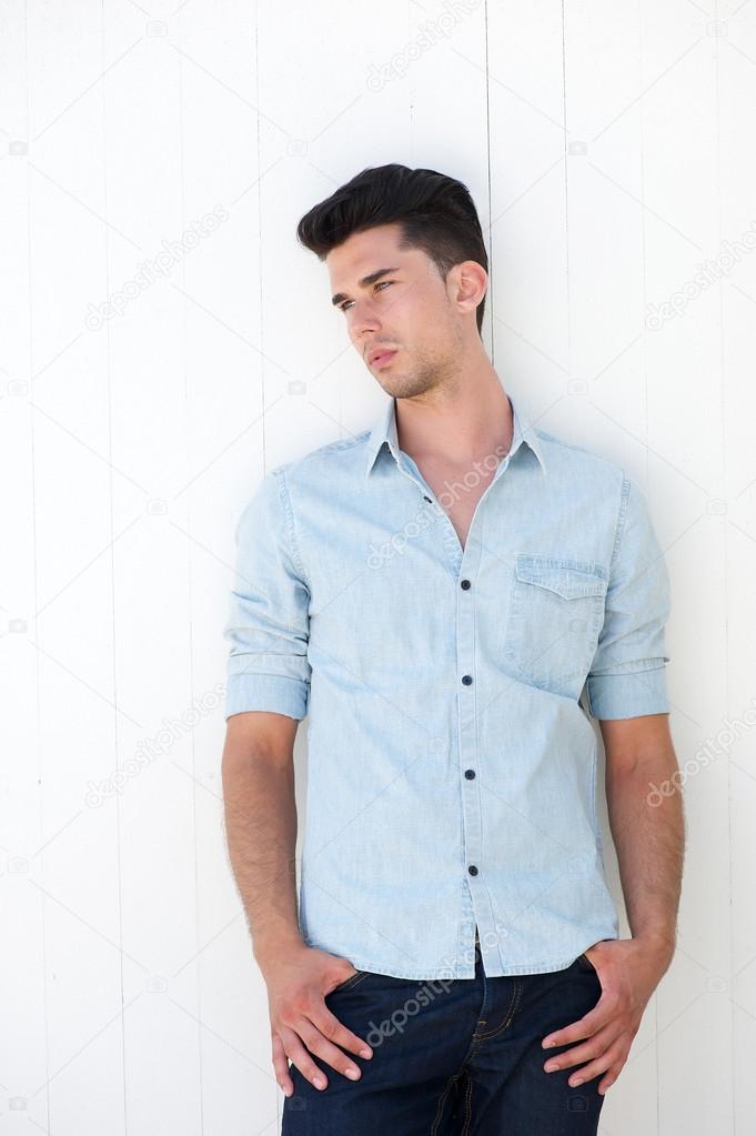 Cute guy standing outdoors with hands in pocket