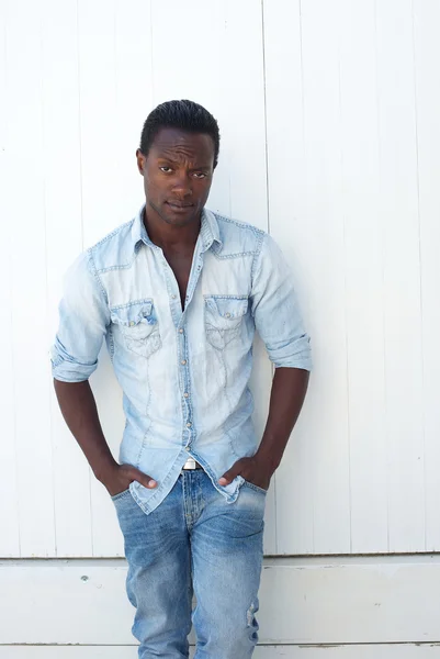 Handsome young man with hands in pocket standing outdoors — Stock Photo, Image