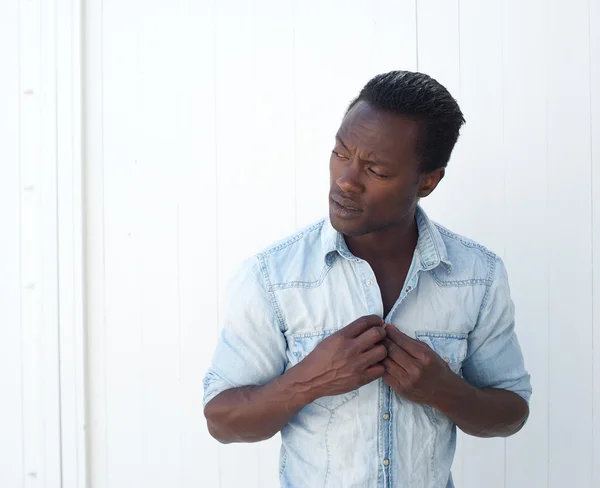 Portrait of a young black man adjusting shirt button outdoors — Stock Photo, Image