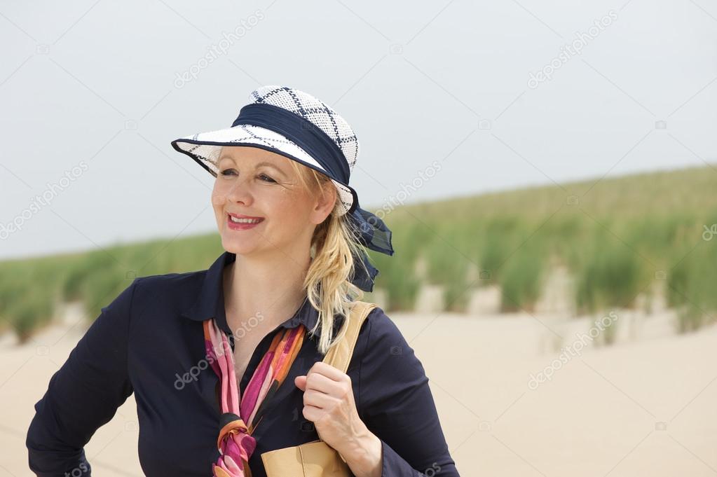 Portrait of a beautiful older woman smiling at the beach