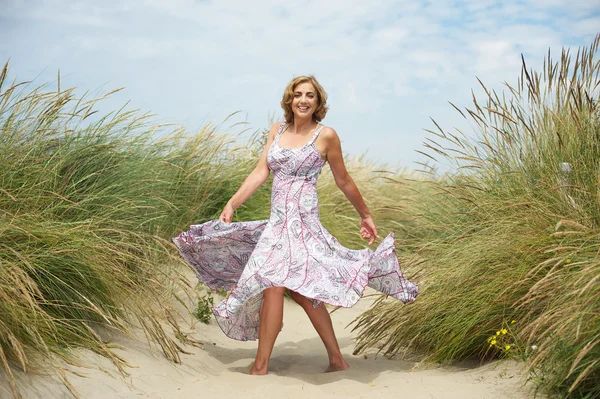 Femme dansant dans le sable à la plage — Photo