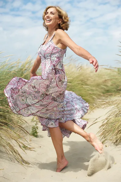 Beautiful middle aged woman dancing outdoors — Stock Photo, Image