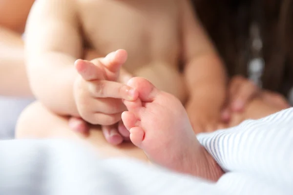 Porträt eines Babys, das mit Zehen spielt — Stockfoto