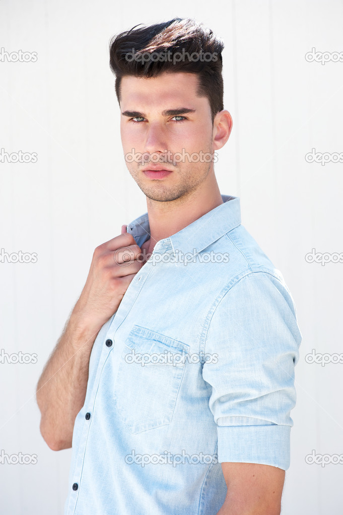 Attractive male fashion model standing on white background