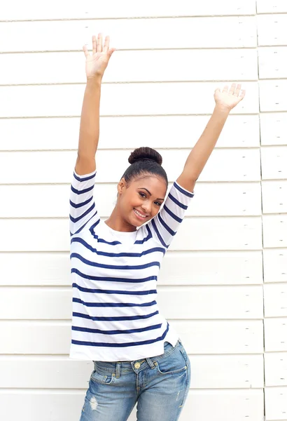 Happy young woman smiling with arms raised — Stock Photo, Image