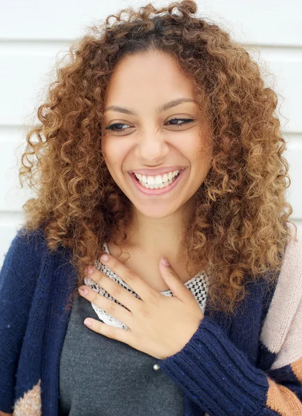 Portrait of a beautiful young woman with curly hair laughing — Stock Photo, Image