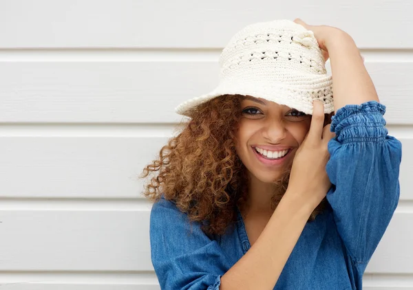 Atractiva joven mujer sonriendo y usando sombrero sobre fondo blanco —  Fotos de Stock