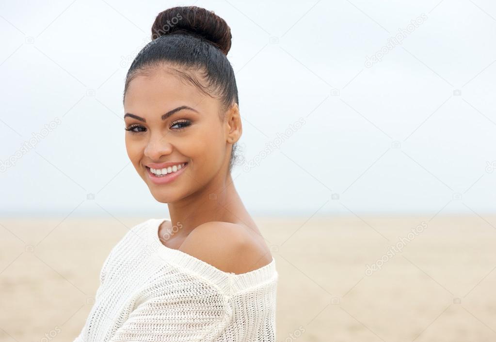 Attractive young lady looking over shoulder and smiling