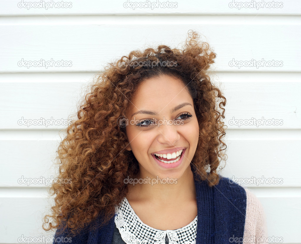 Beautiful young woman laughing outdoors