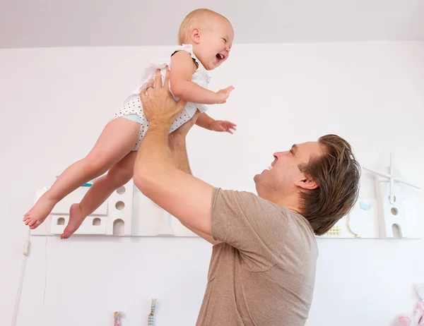 Portrait of a loving father playing with cute baby at home — Stock Photo, Image