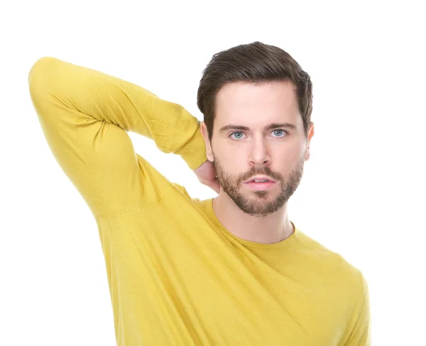portrait of a young man with yellow shirt with serious expression