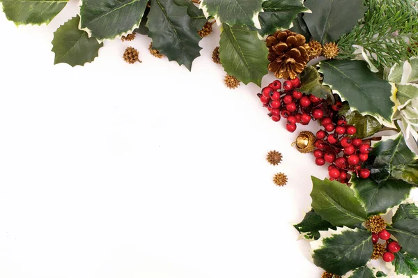 Christmas decoration arrangement with holly, berries and pine cones