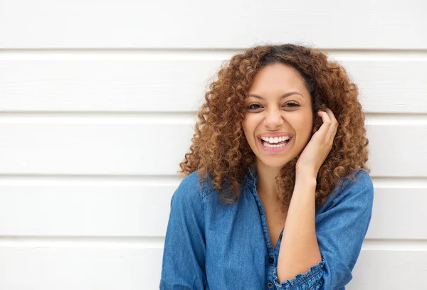 Portrait of a beautiful woman laughing with hand in hair — Stock Photo, Image