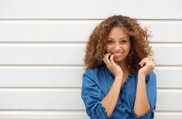 Portrait of a cheerful young woman posing with hand in hair — Stock Photo, Image