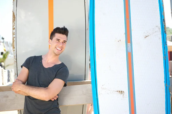 Happy man smiling outdoors with surfboard — Stock Photo, Image