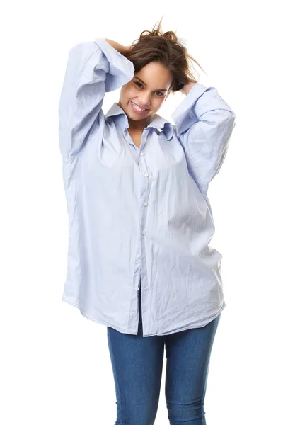 Young woman in smiling in casual clothing with hands in hair — Stock Photo, Image