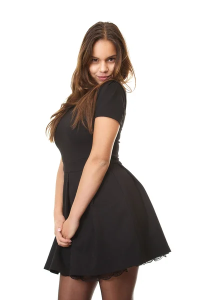 Застенчивая девушка в черном платье — стоковое фото