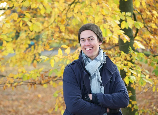 Portrait of a happy young man smiling outdoors in warm clothing — Stock Photo, Image
