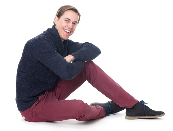 Portrait of a relaxed young man sitting and smiling — Stock Photo, Image