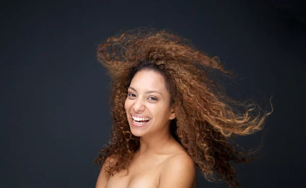 Beautiful young woman with curly hair laughing — Stock Photo, Image