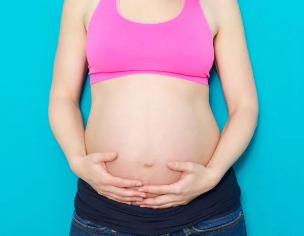 Close up mother holding pregnant stomach — Stock Photo, Image