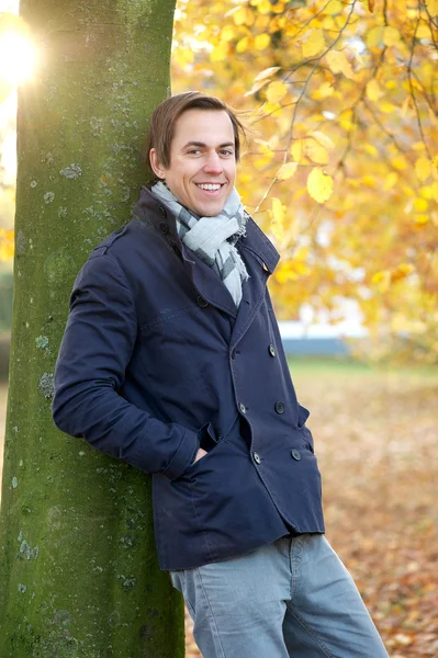 Relaxed man smiling outdoors on an Autumn day — Stock Photo, Image