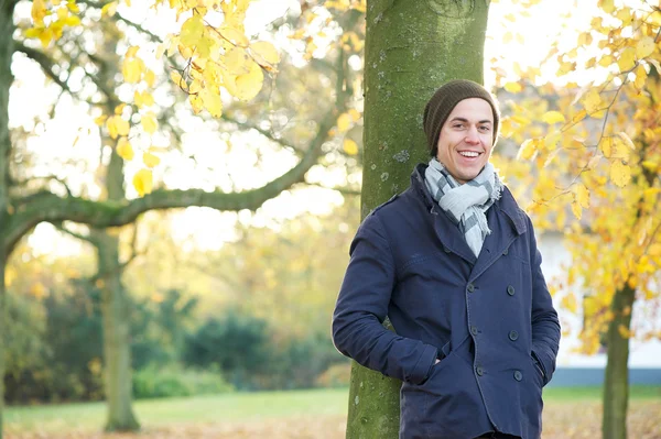 Attractive young man standing outside on an autumn day — Stock Photo, Image