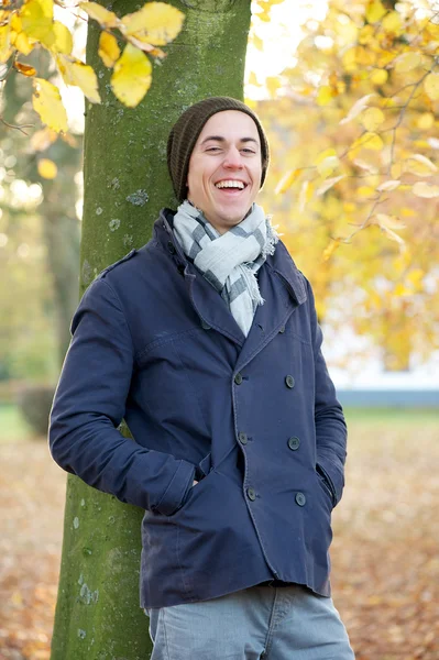 Young man laughing outdoors on a fall day — Stock Photo, Image