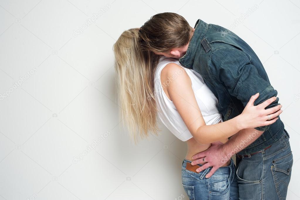 Young man kissing blond female