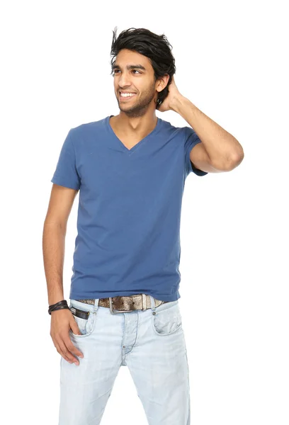 Happy young man smiling with hand in hair — Stock Photo, Image