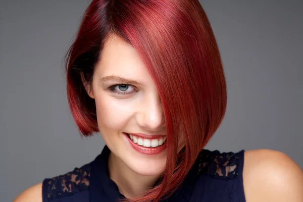 Beautiful young woman with red hair smiling — Stock Photo, Image