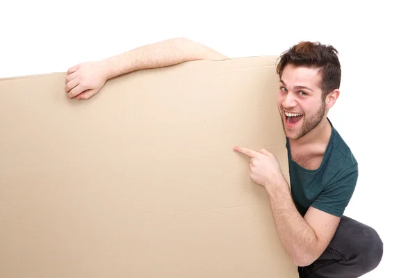 Man smiling pointing finger to empty space — Stock Photo, Image