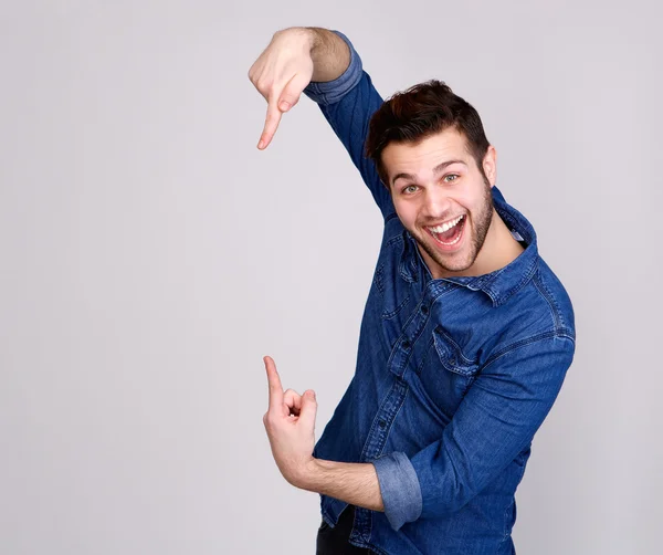Man smiling and pointing to copy space — Stock Photo, Image