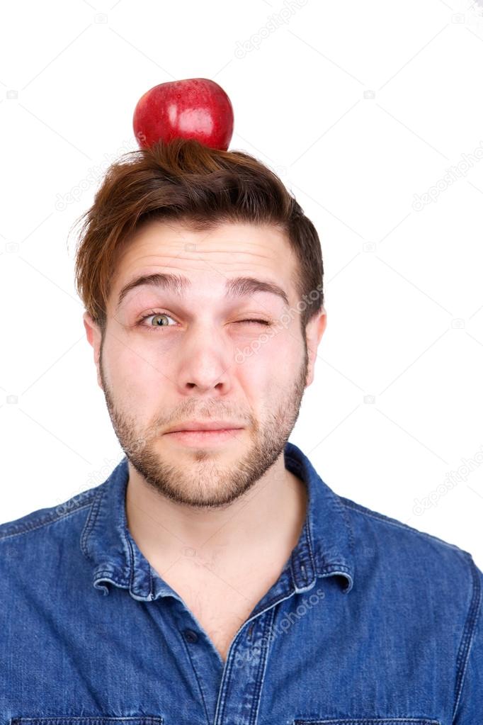 Balancing red apple on head