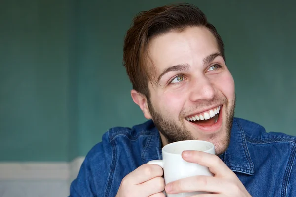 Man die lacht met kop koffie — Stockfoto