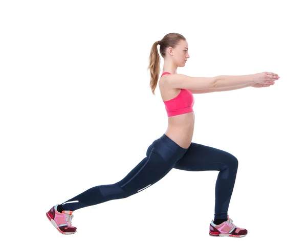 Mujer joven estirando los músculos de las piernas —  Fotos de Stock