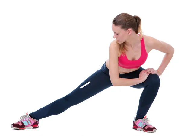 Young woman stretching leg muscles — Stock Photo, Image