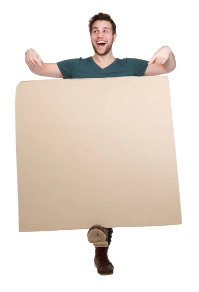 Young man pointing to empty poster — Stock Photo, Image