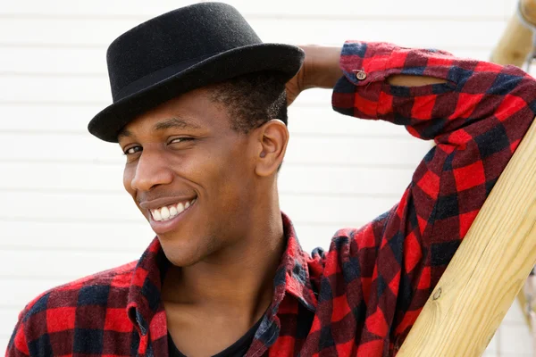 Hombre sonriendo con sombrero al aire libre — Foto de Stock