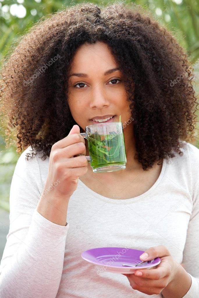 Young woman drinking tea outdoors