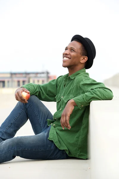 Trendy young man with apple — Stock Photo, Image