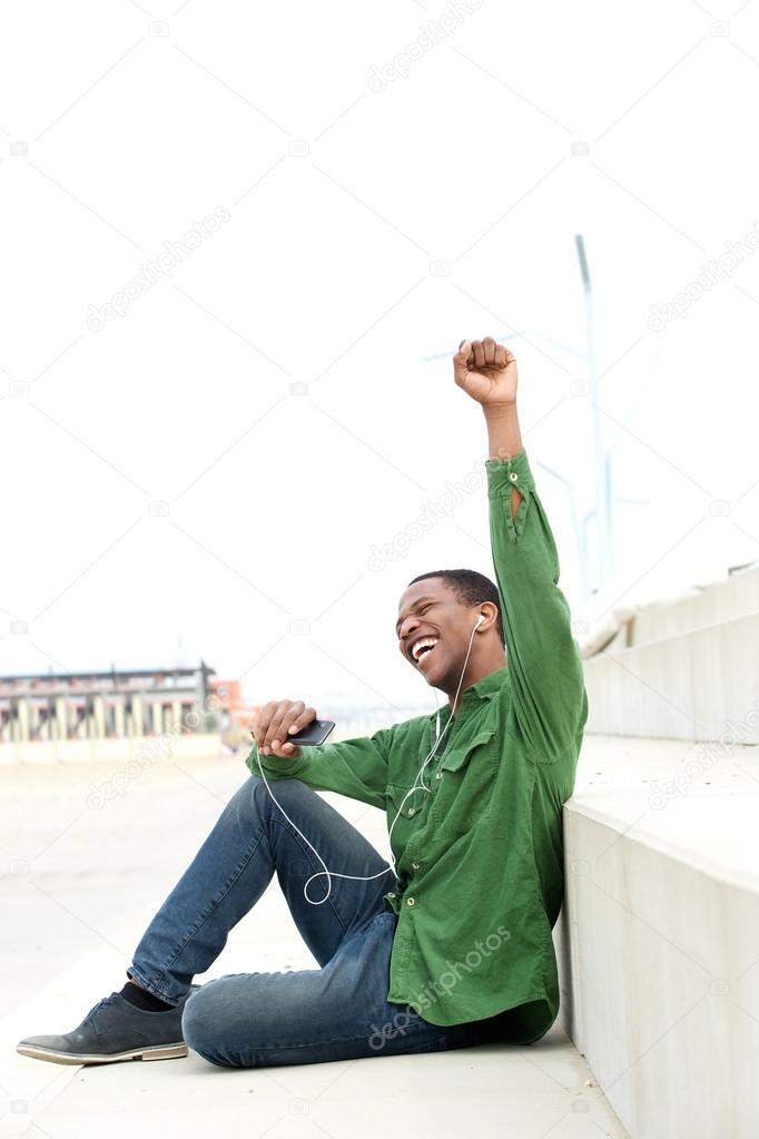 man with mobile phone celebrating